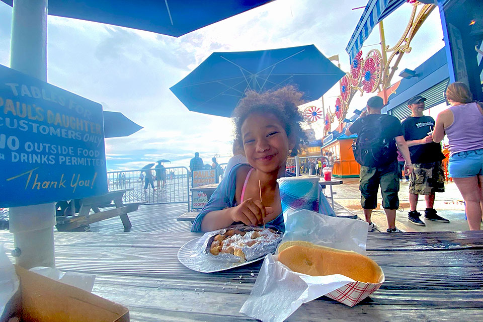Noshing on a funnel cake on the Coney Island boardwalk is a sweet ending to an epic day of summer fun. 